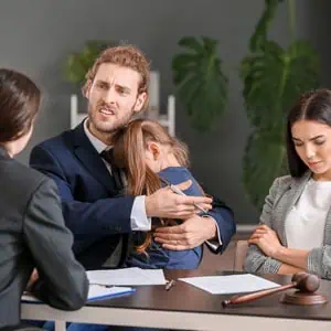 Business couple with baby and another girl at table - DC Nguyen Law